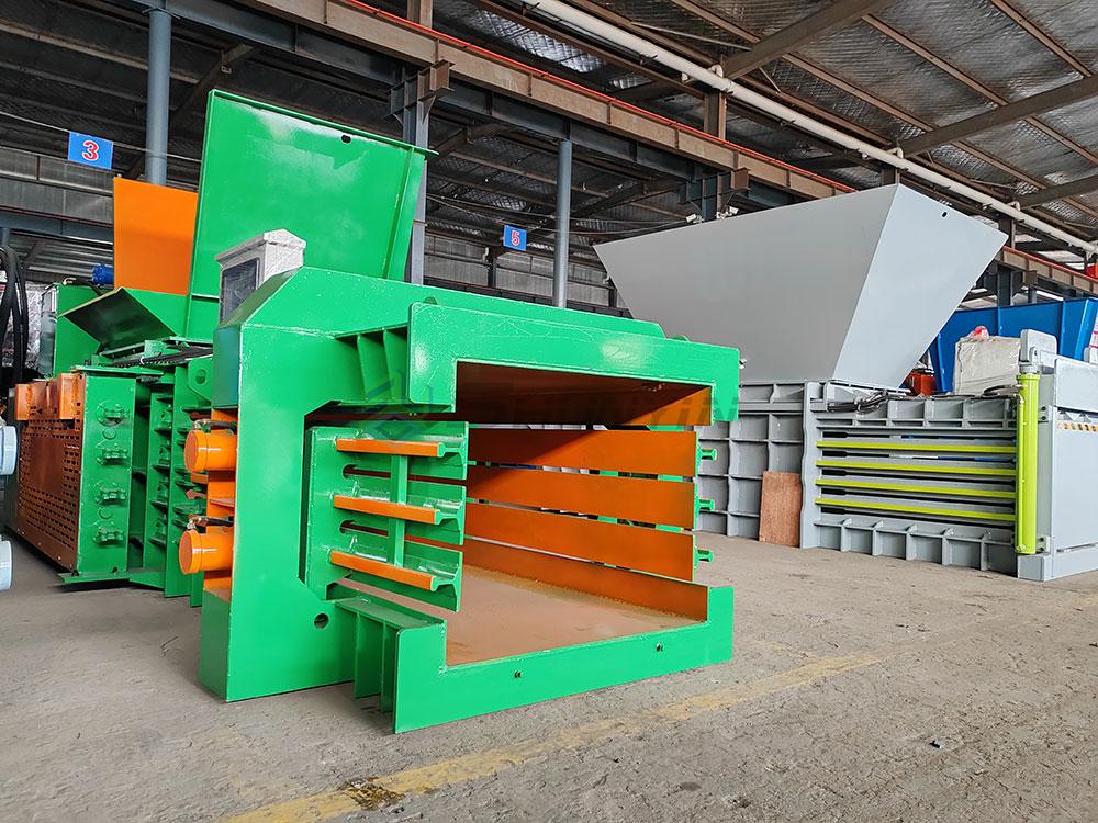 Horizontal baler with built-in feeding system for faster material input and processing.
